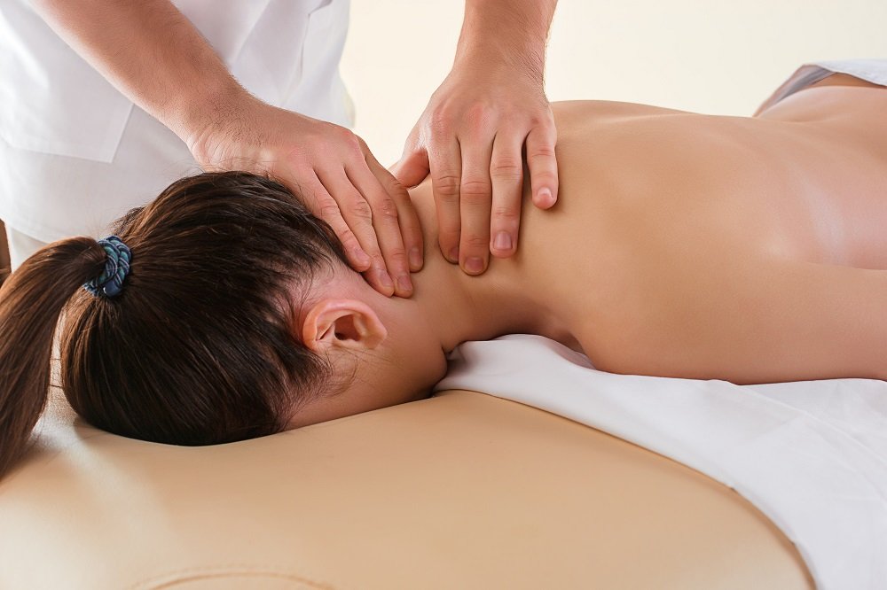 The picture of beautiful woman in massage salon and male hands close up
